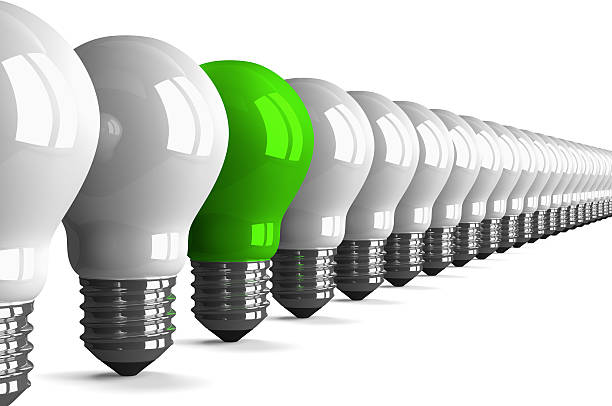 istock Green tungsten light bulb and many white ones, perspective view 511713279