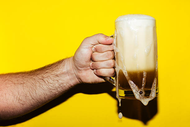 Beer glass on red checkered background. Top view