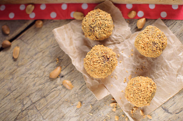 istock Sweet peanut balls on wooden background 511720294