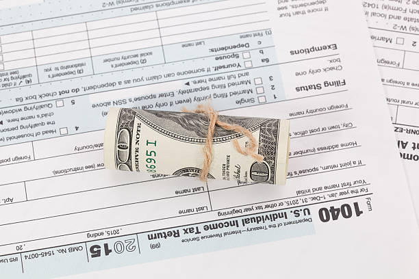 istock Money on tax form background 511720344