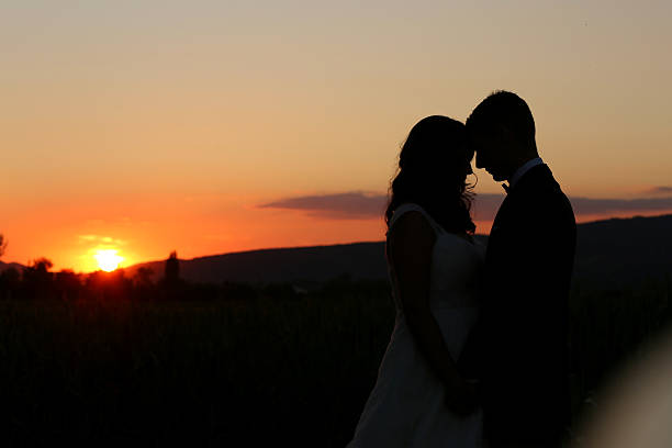 istock Silhouette of bride and groom at sunset 511720680