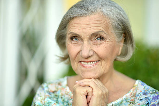 istock senior woman in summer park 511721228