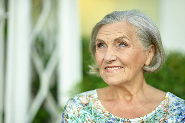 istock senior woman in summer park 511721452