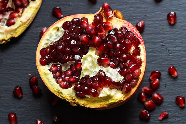 istock Red juicy pomegranate on dark background 511721666
