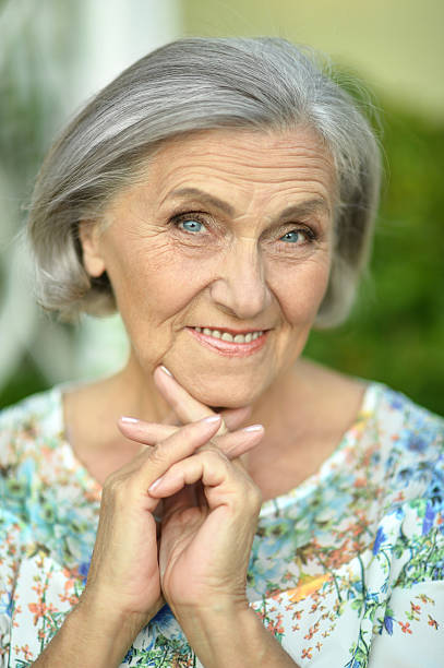 istock senior woman in summer park 511721860