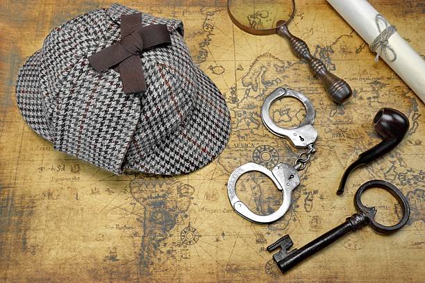 istock Overhead View Of Deerstalker Hat And Detective Tools On Map 511722458