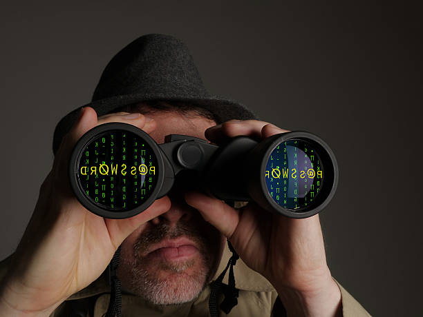 Conceptual Image of a Data Spy Looking for Passwords stock photo