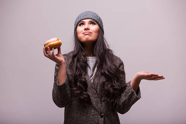 istock Beautiful sensual woman eat a donuts at camera. Nice smack 511723516