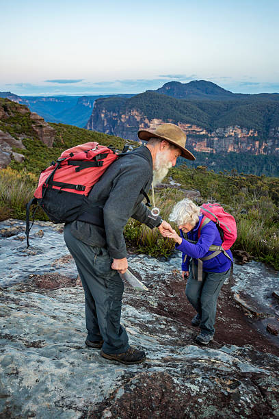 istock Senior Man Helping His Wife While Bushwalking in Spectacular Landscape 511723738