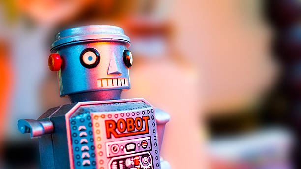 istock Toy robot with broken arm and staring eyes 511725952