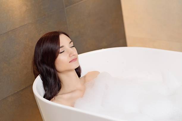 istock woman relaxing in bath with foam 511725954