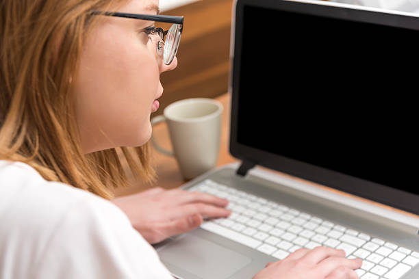 istock Pretty young woman using a laptop 511726644