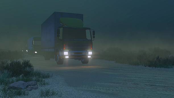 istock Military trucks on a dirt road at night 511726832