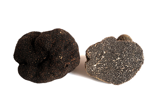 sliced black truffel (tuber melanosporum) isolated on white