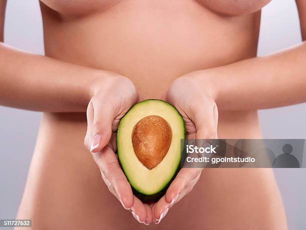 Naked Woman Holding The Fresh Avocado Stock Photo - Download Image Now - Avocado, Breast, Adult