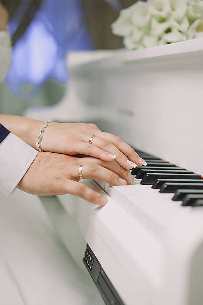 istock Bride and groom hands on the piano tiles 511728640