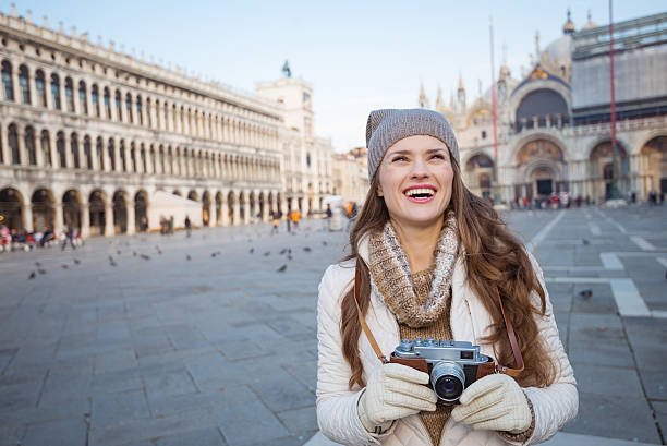 istock Woman holding photo camera on Piazza San Marco 511732504