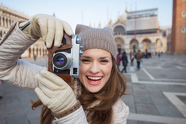 istock Woman taking photos with retro photo camera, Piazza San Marco 511732664