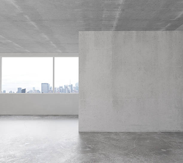 White wall in empty loft room with concrete floor