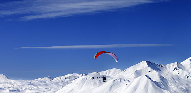 istock Panoramic view on sky gliding in snowy mountains 511735434
