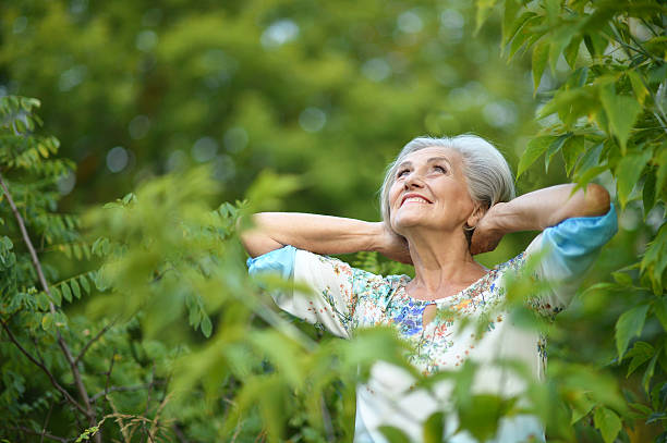 istock senior woman in summer park 511735946