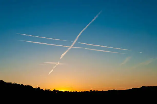 god`s cross - condensation trail on evening sky