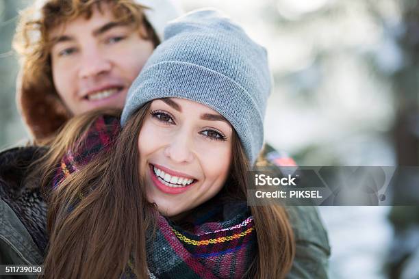 Portrait Of Smiling Young Couple Stock Photo - Download Image Now - Knit Hat, Snow, Winter