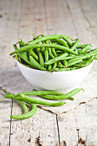 green string beans in a bowl stock photo