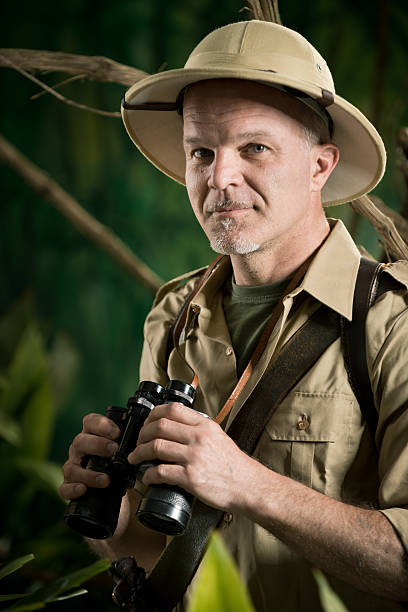 istock Adventurer in the jungle with binoculars 511740878