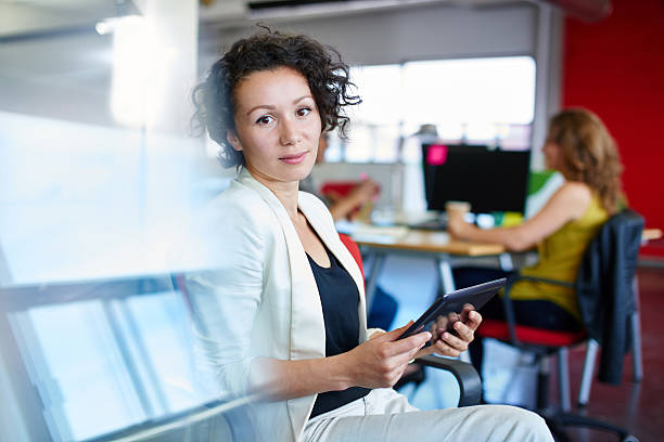 istock Confident female designer working on a digital tablet in red 511741042
