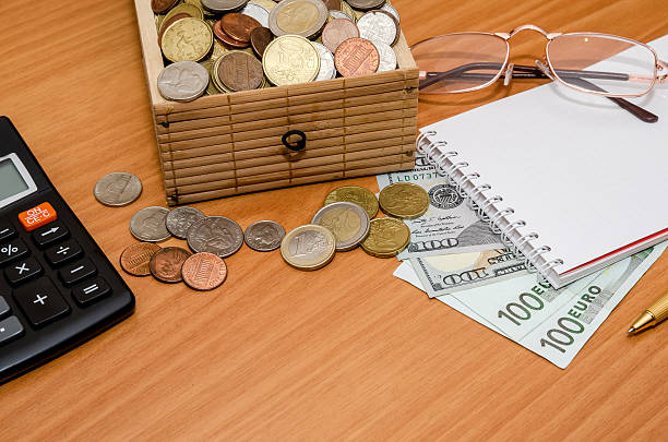 istock open treasure chest with coin. Us dollar and euro, notepad 511744154
