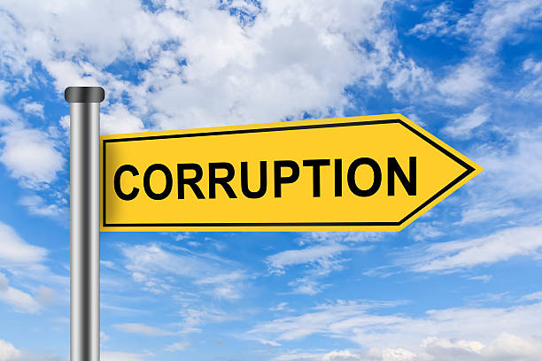 istock yellow road sign with corruption words 511744743