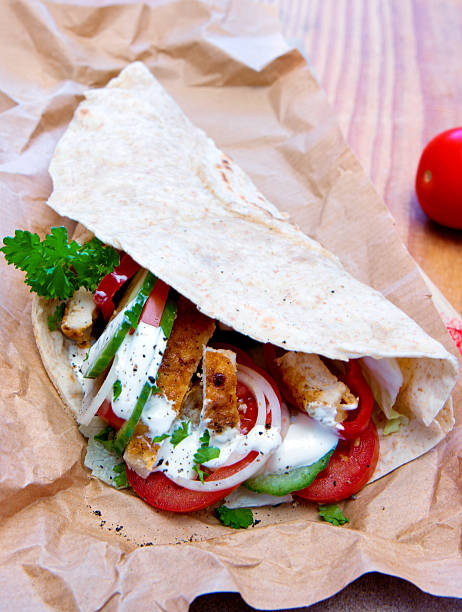 istock Tortilla wrap with chicken breast and vegetables. 511745694
