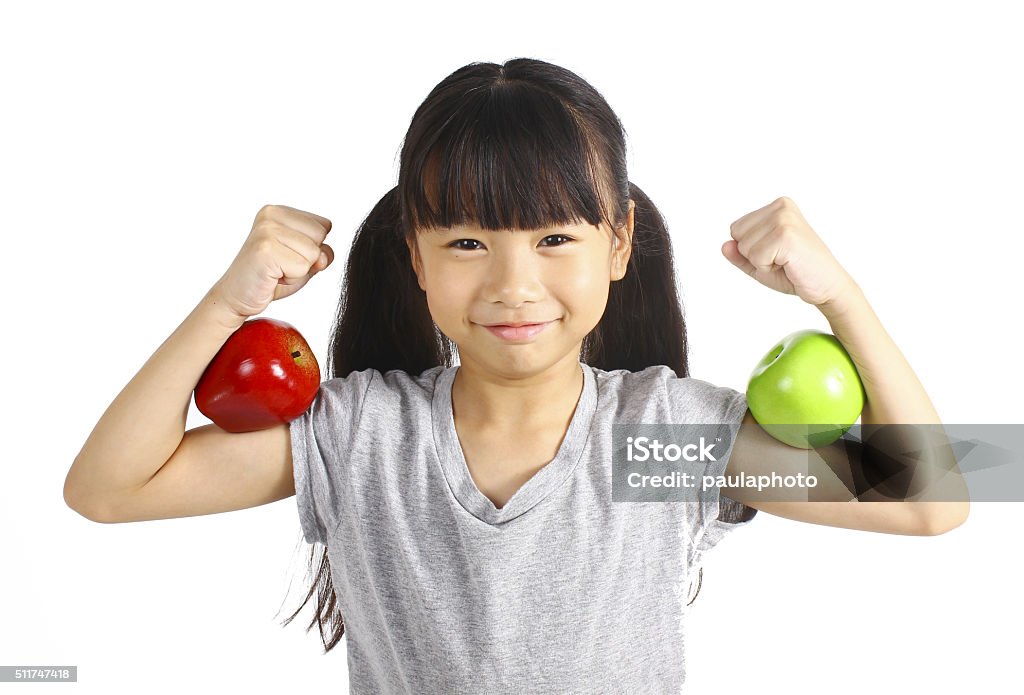 Healthy girl A little girl flexes her muscle while showing off the apple that made her strong and healthy  Child Stock Photo