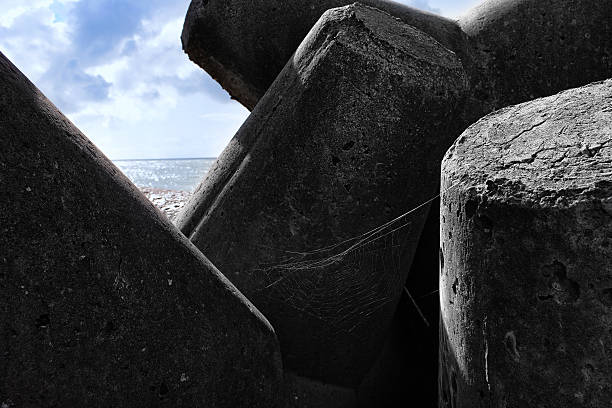 istock Concrete barriers from storm at sea 511748626