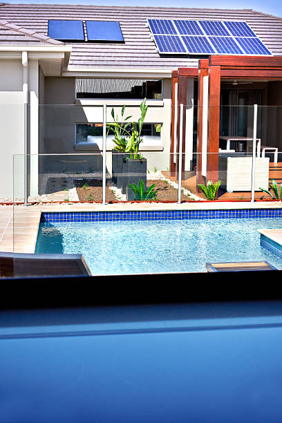 istock Modern swimming pool and a house with solar panels 511748698