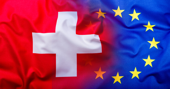 Flags of the Switzerland and the European Union. Switzerland Flag and EU Flag. World flag money conceptFlags of the Switzerland and the European Union. Switzerland Flag and EU Flag. World flag money concept