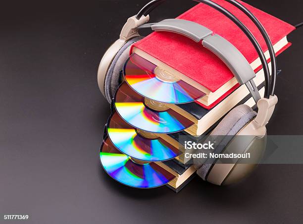 Cd Sticks Out From Red Books With Headphones On It Stock Photo - Download Image Now - Book, DVD, Library