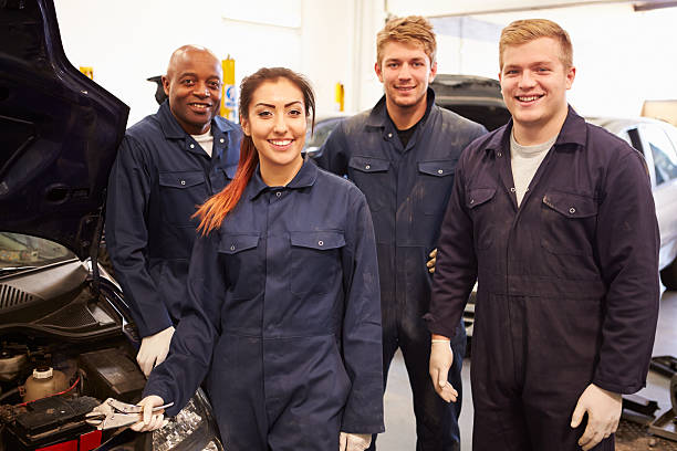 istock Teacher Helping Students Training To Be Car Mechanics 511773083
