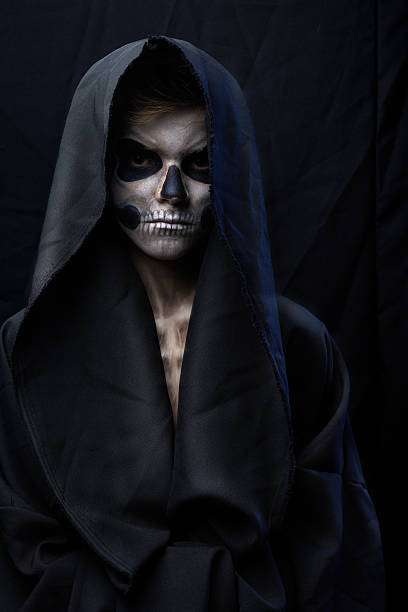 angry teenager with makeup skull cape