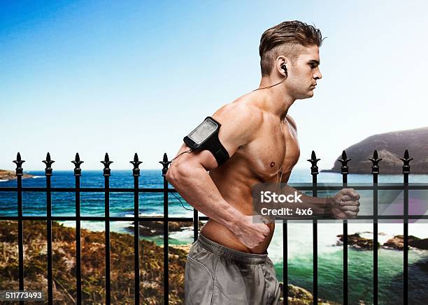 Muscular Man Running In Front Of Beach Stock Photo - Download Image Now - 20-24 Years, 20-29 Years, Adult