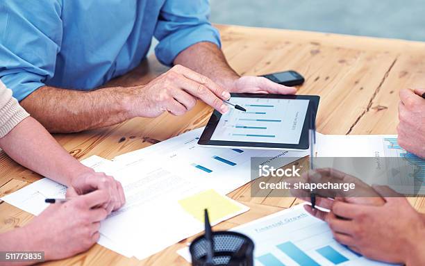 Working Through The Figures Stock Photo - Download Image Now - Business Meeting, Digital Tablet, Graph