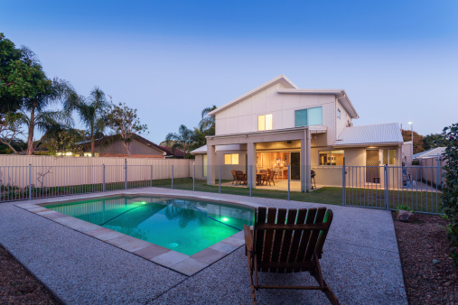 Modern home at dusk with swimming pool