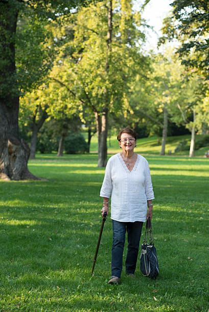 istock Mature woman walking in the park 511776331