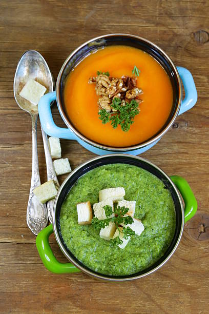 istock two kinds of cream soup (broccoli and pumpkin) in pot 511778097