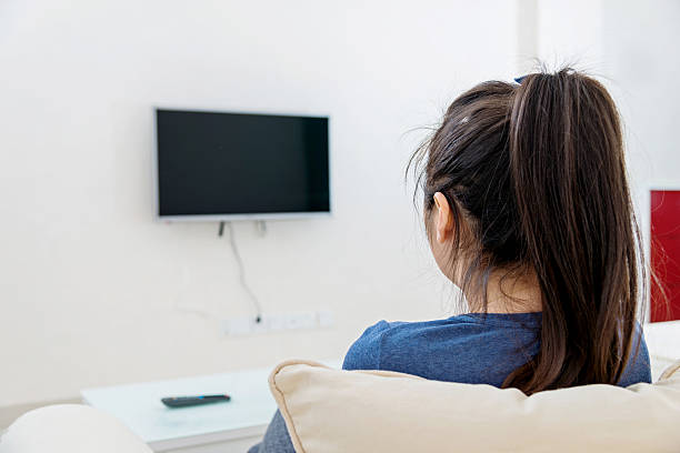 istock asian woman watching TV 511782870