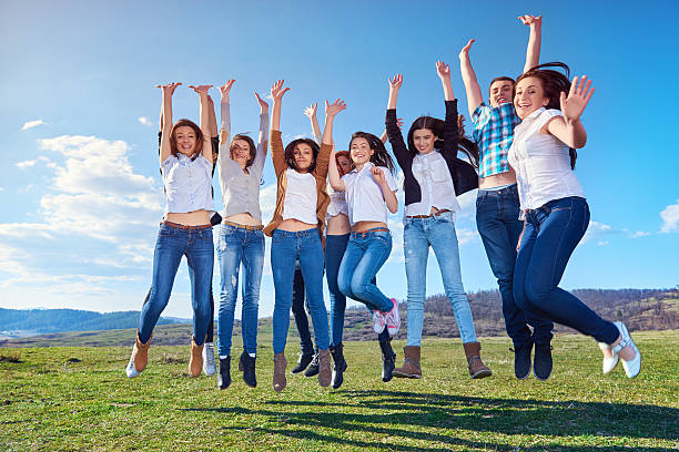 istock happy friends jumping in summer day 511785966