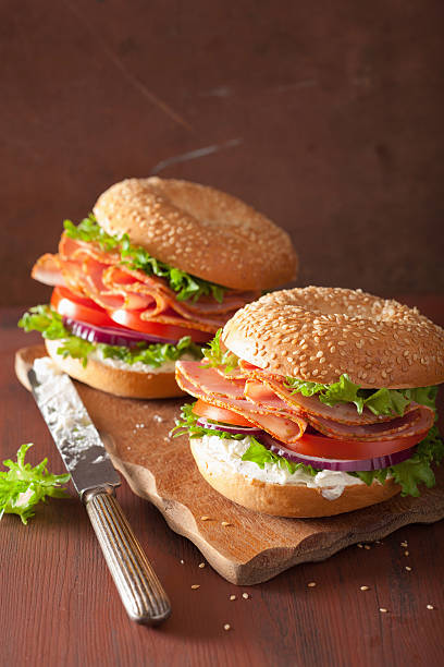 istock ham sandwich on bagel with cream cheese tomato onion 511788254
