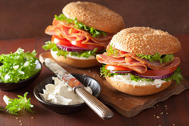 istock ham sandwich on bagel with cream cheese tomato onion 511788350