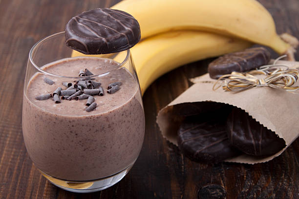 Delicious dessert smoothie of banana with sand chocolate cookies stock photo